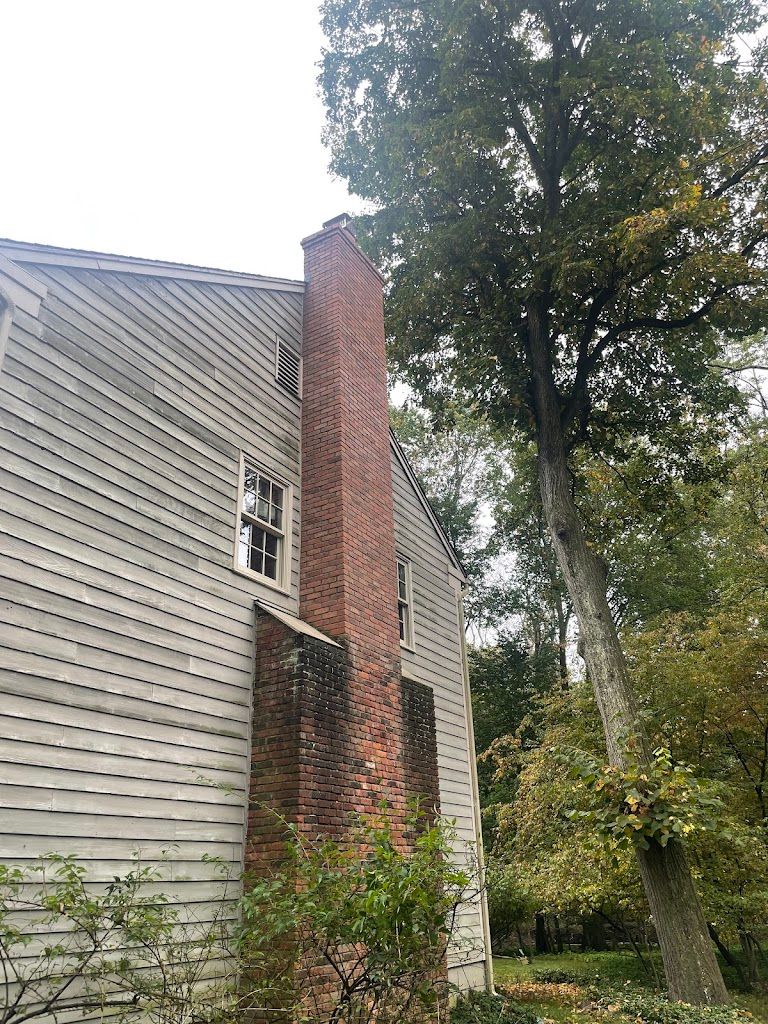 Tall brick chimney running up the side of a two-story home