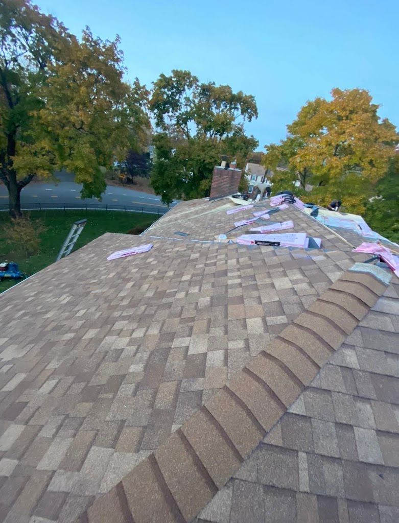 Close view of a finished architectural shingle roof and ridge cap