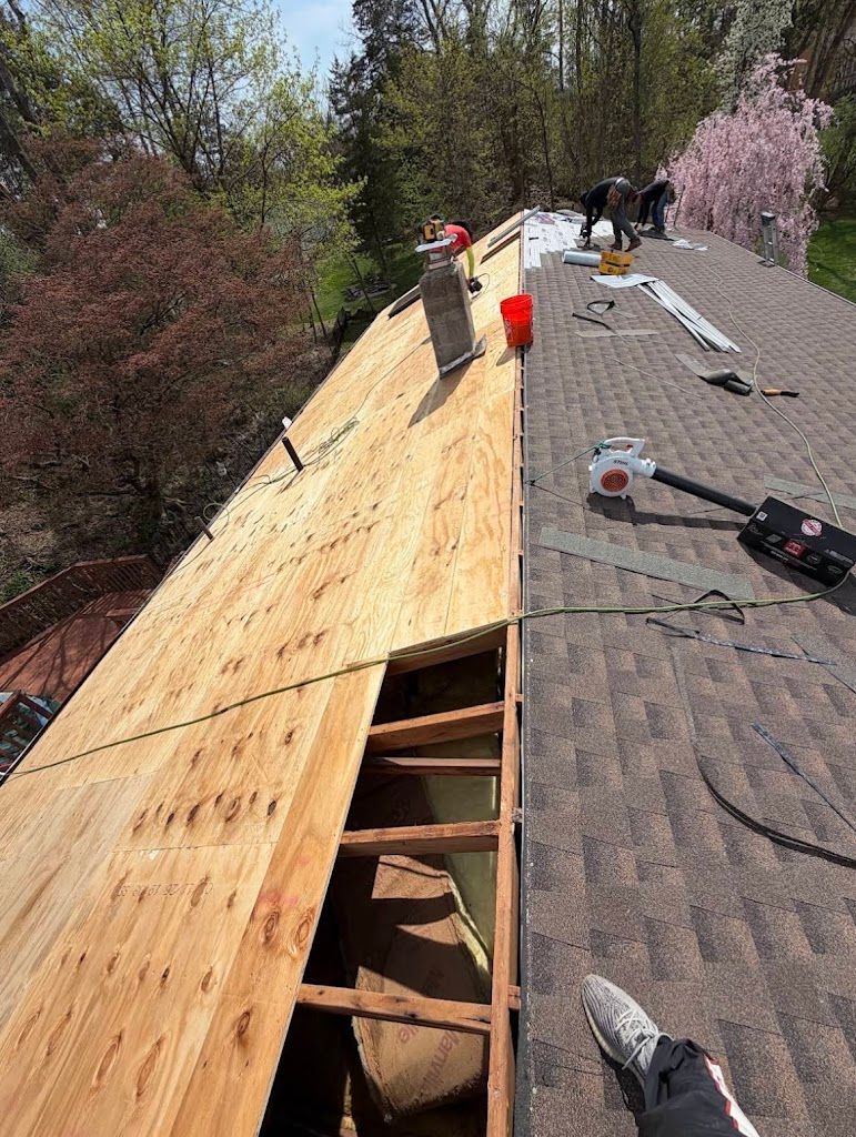 New plywood decking going down next to the old shingles during a tear-off