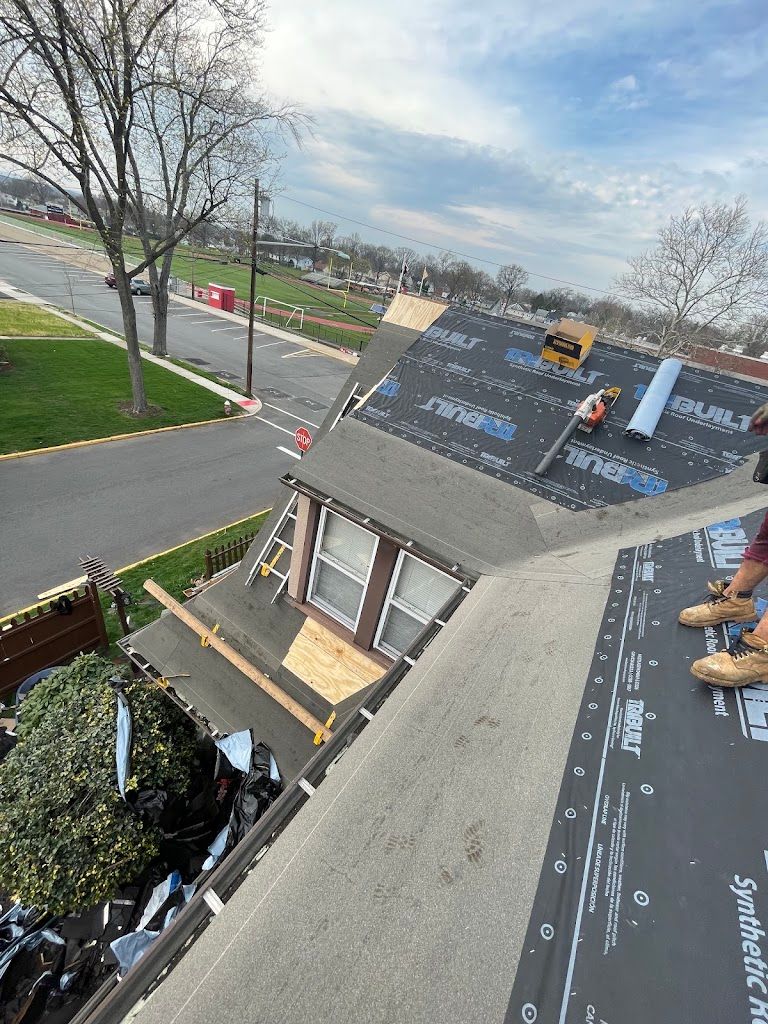 Synthetic underlayment installed across a roof with a front dormer